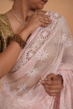 Pink colored check organza saree with tapechi embroidery