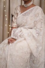 White colored silk organza saree with delicate tapechi embroidery and cutwork