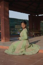 Woman in green traditional attire.