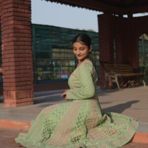 Woman in green traditional attire.