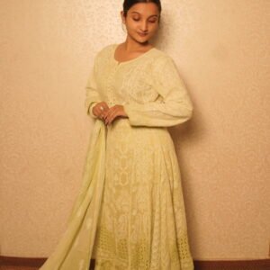 Woman in elegant traditional light green attire.