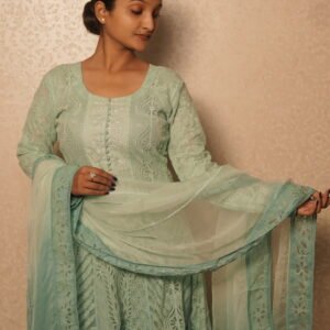 Woman in elegant light green attire.