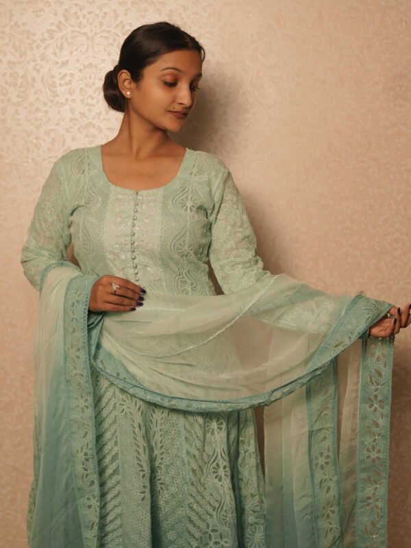 Woman in elegant light green attire.