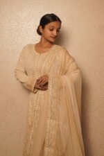 Elegant woman in traditional beige anarkali.