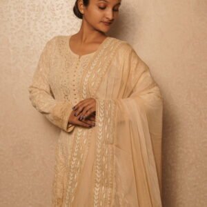 Elegant woman in traditional beige anarkali.