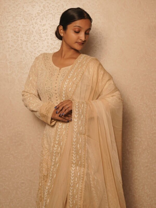 Elegant woman in traditional beige anarkali.