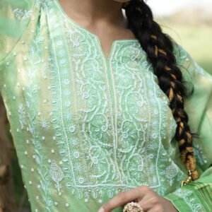 Woman in green embroidered outfit