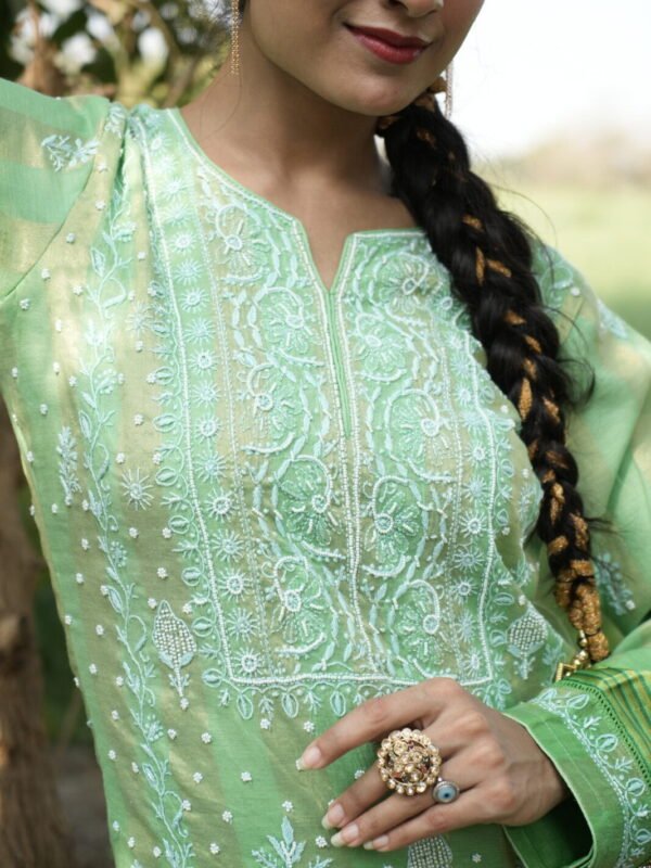 Woman in green embroidered outfit