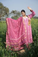 Person in traditional pink attire outdoors