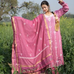 Person in traditional pink attire outdoors