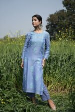 Woman in blue ethnic attire outdoors