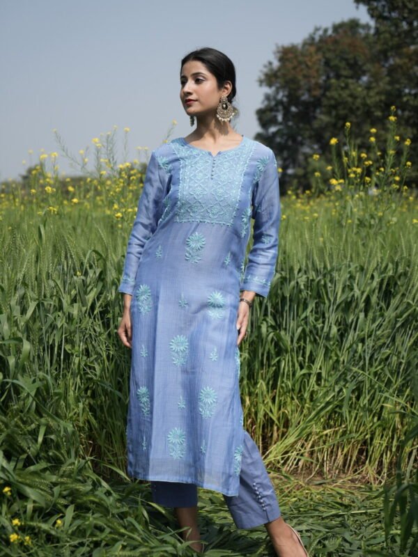 Woman in blue ethnic attire outdoors